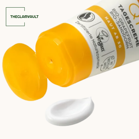 Yellow tube of cream with a white label on a white background, featuring the brand 'THEGLAMVAULT'.