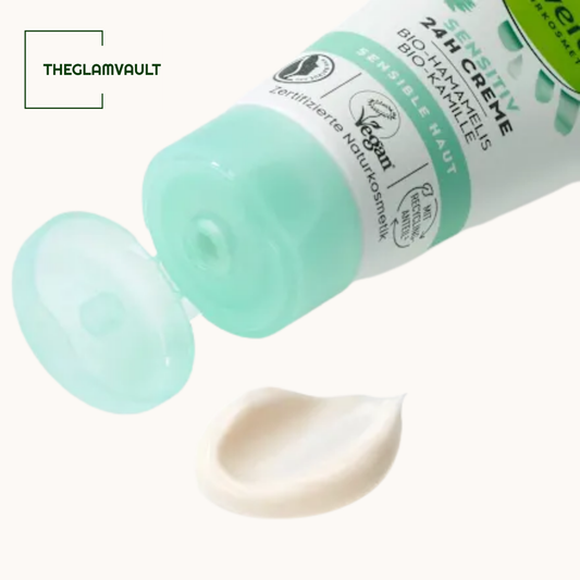 Tube of cream with a sample on a white background, featuring the brand 'THEGLAMVAULT'.