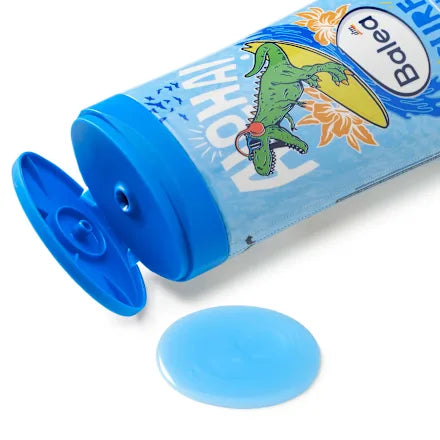 Blue bath bomb with packaging featuring a dinosaur illustration on a white background
