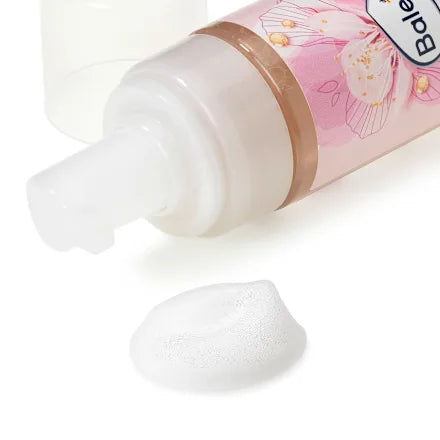 Lotion bottle with floral design on a white background
